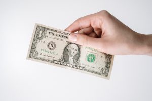 Hand holding a dollar.